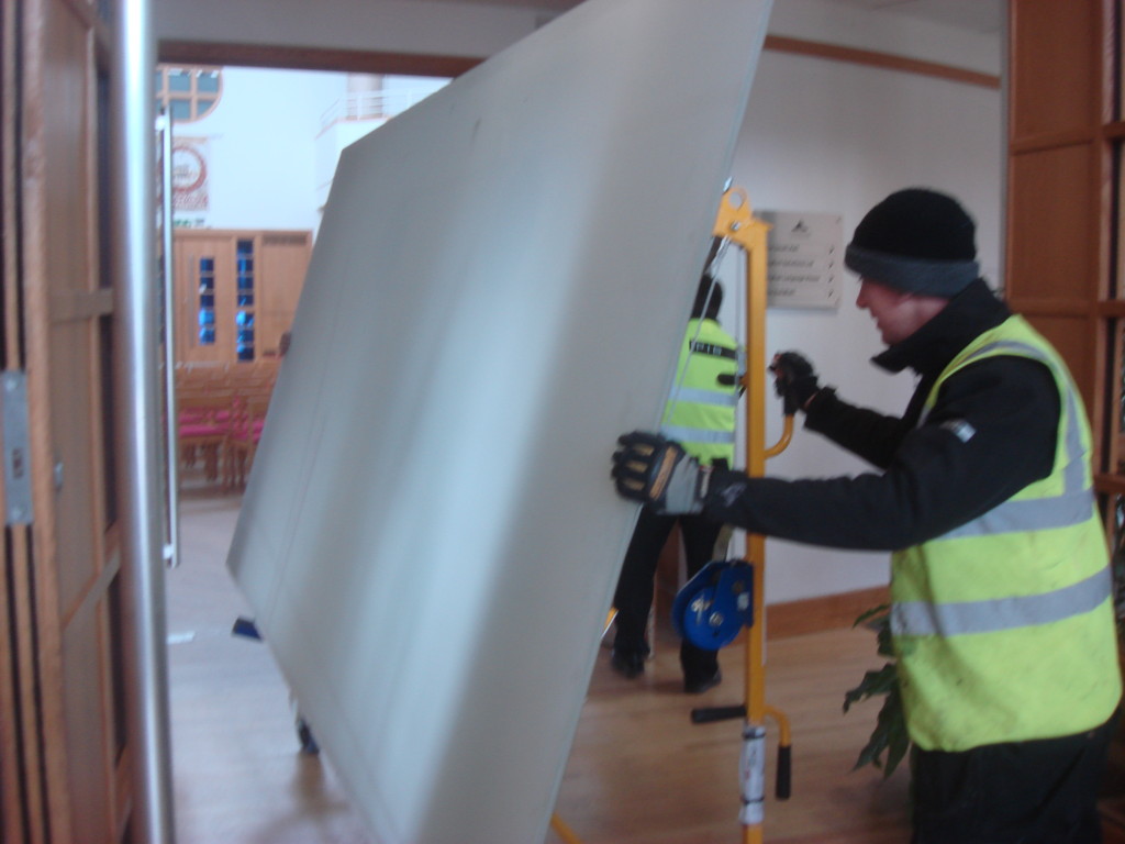 Glass sheets of cross being wheeled through Reception