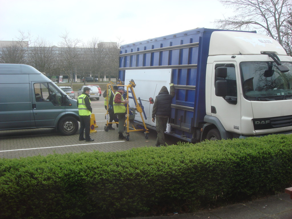 Glass sheets being off-loaded from delivery van